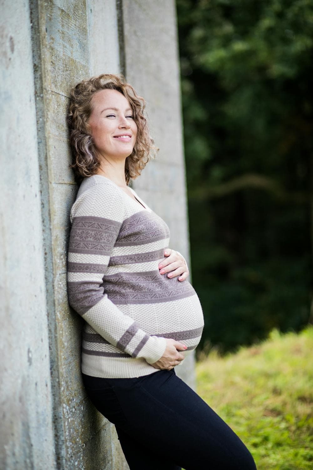 Pregnant woman smiling outdoors